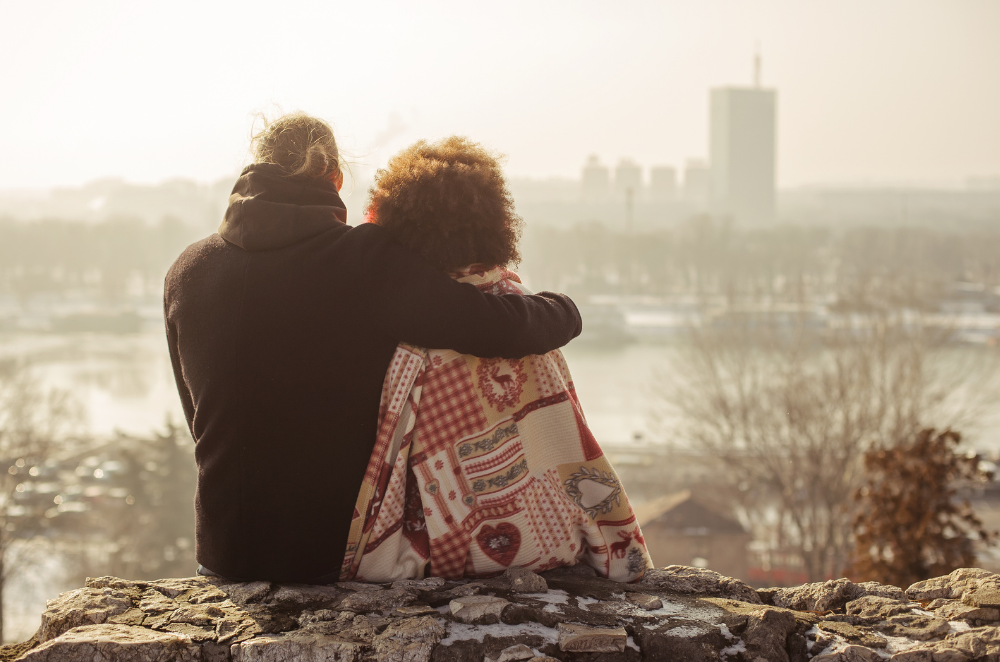 Couple sitting together overlooking a city skyline